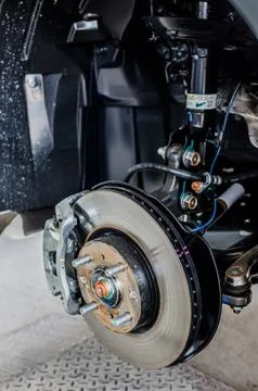 Front disc brake on car in process of new tire replacement. The rim is remove Foto stock