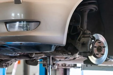 Front disc brake on car in process of service. The rim is removed showing the Stock Photos