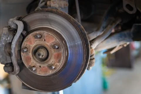 Front disc brake on car in process of service. The rim is removed showing the Stock Photos