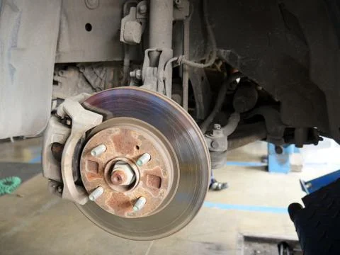 Front disk brake system of the car after remove the tire for repair and maint Stock Photos