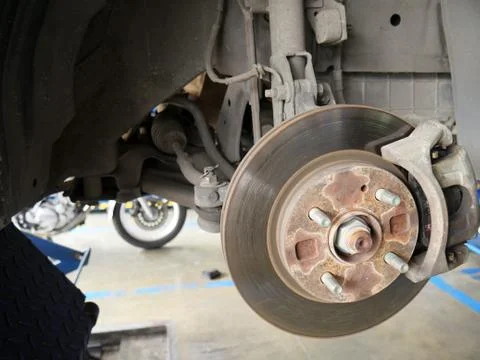 Front disk brake system of the car after remove the tire for repair and maint Stock Photos
