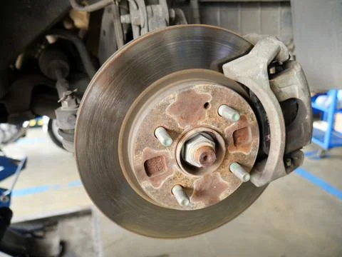 Front disk brake system of the car after remove the tire for repair and maint Stock Photos