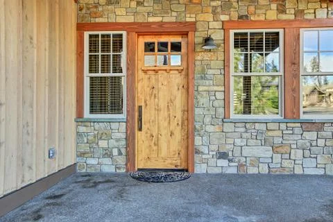 Front door entry with stone wall. Stock Photos