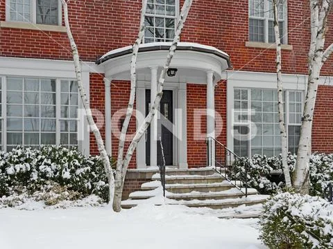 Front door of older brick house in winter Stock Photos