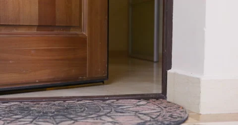 The front door is open for ventilation, but a draft has slammed it shut, low Stock Footage 185793674