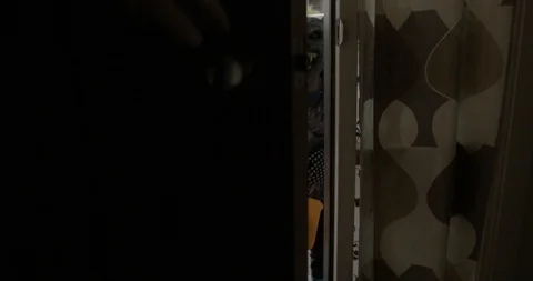 A front door opens to two young children trick or treating Video stock 115412848