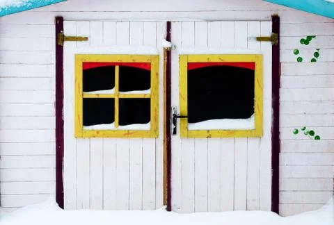 Front doors with windows frames. of a multi-colored wooden chalet in park dur Stock Photos