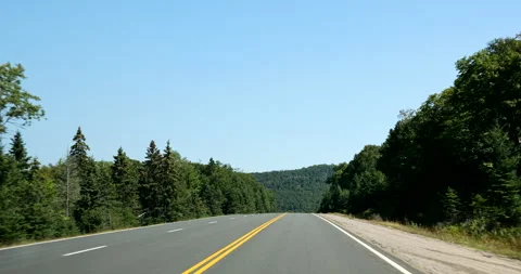 Front driving plate on the highway through the forest of Ontario Canada Stock Footage 287485694
