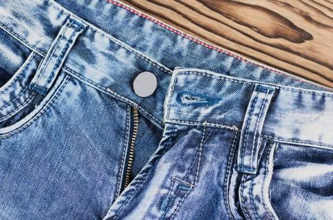 Front empty pockets and unbuttoned zipper on blue jeans Stock Photos