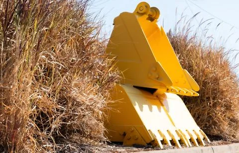 Front End Loader Buckets in Dry Grass Stock Photos