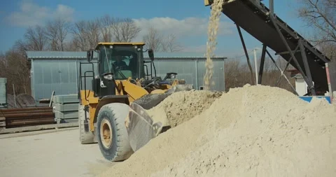 A front-end loader collects sand at a concrete plant Stock-Footage 277595755