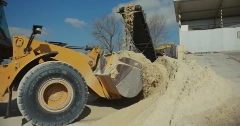 A front-end loader collects sand at a concrete plant Video stock 277595846