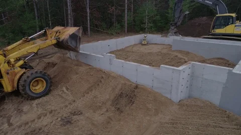 Front End Loader Dumping Dirt on Concrete Foundation | Aerial Drone Vídeo Stock 81754032
