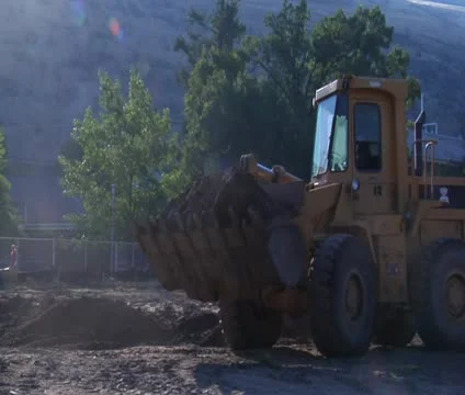 Front-end loader dumps dirt Stock Footage 21561626