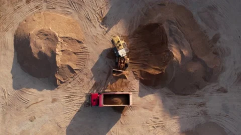 Front end loader load sand and gravel in dump truck in open pit. Heavy machinery Video stock 194817816