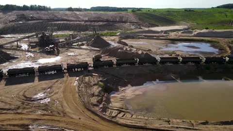 Front-end loader loading sand it to the freight train. Mining work in open pit. Stock Footage 156596993