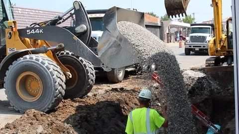 Front End Loader pouring filler white rock. Stock Footage 103181189