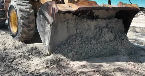 Front end loader pushes a mass of sand along the beach Stock Footage 323313608