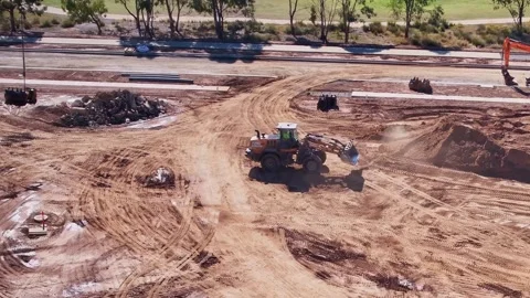 Front end loader scooping dirt Stock Footage 338064636
