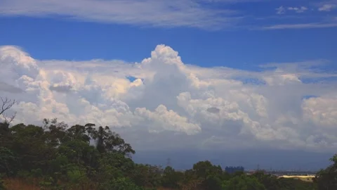 In front of eyes, billowing clouds fly over the mountain and valley city. Stock Footage 277946773