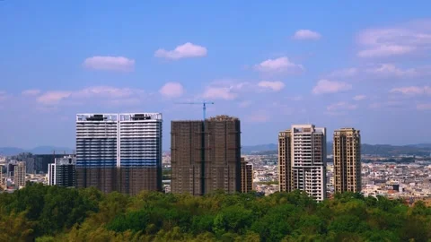 In front of eyes, billowing clouds fly over the city and forest . Video stock 280137799