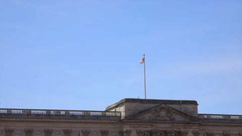 Front facade of Buckingham Palace with the Union Jack flag flying overhead Stock Footage 320334820