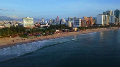 Front facing drone flight over Da Nang beach at sunrise with gentle waves Stockbeeldmateriaal 340536471