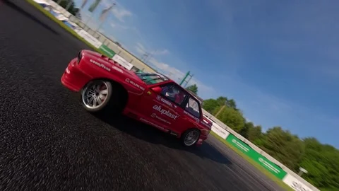 Front Facing FPV Drone Transition to Tandem Drift Chase on Wet Track Stock-Footage 336101503