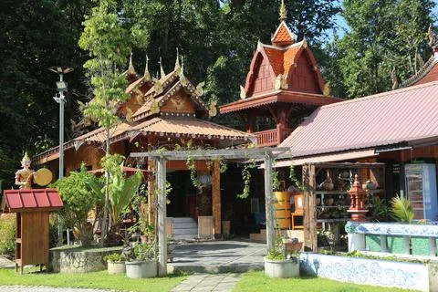 The front of the fairground is surrounded by trees, with thai-style buildin.. Foto stock