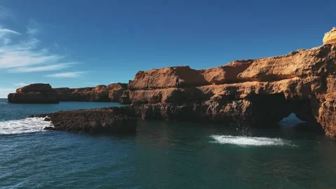 Front flip into the ocean. Cliff jump. Drone, stationary. Stock-Footage 296209569