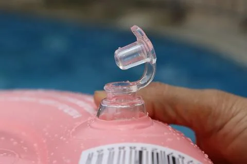 Front focus of a open inflatable valve of a swimming tube. Stock Photos