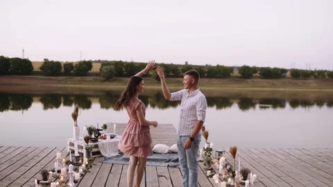Front frame, couple in love walking on a wooden pond. Bridge arranged with Stock Footage 140876459