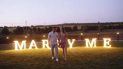 Front frame with a couple walking hugging. Cheerful romantic couple. Charismatic Stock Footage 140878145