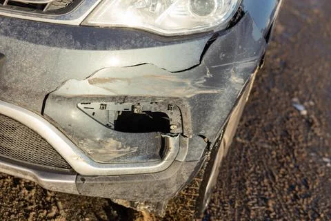 Front of gray crossover car get damaged by crash accident on the road. Stock Photos