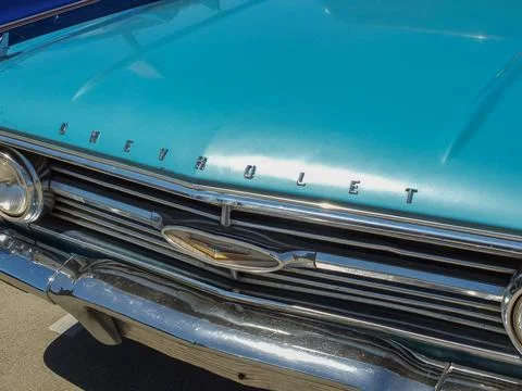 Front grill and emblem of a blue classic Oldsmobile F-85 car at a show in R.. Фото