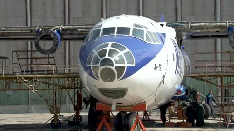 In front of hangar there is An-12 aircraft with number RA-11310 of Irkut Stock Footage 171272499