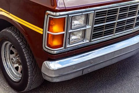 Front headlight and chrome bumper of vintage brown van Stock Photos