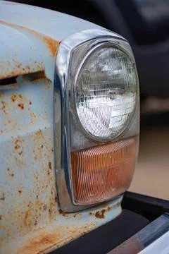 Front Headlight view of a classic blue car Stock Photos