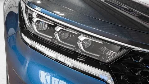 Front headlight xenon light of modern car close-up view Stock Photos
