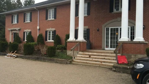 Front of House Pan to Yard Stock Footage 89990752