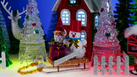 In front of the house there is a gnome and a snowman on a sled Stock Footage 322510686