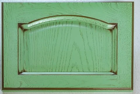 The front of the kitchen door is made of solid oak, covered with green paint  Stock Photos