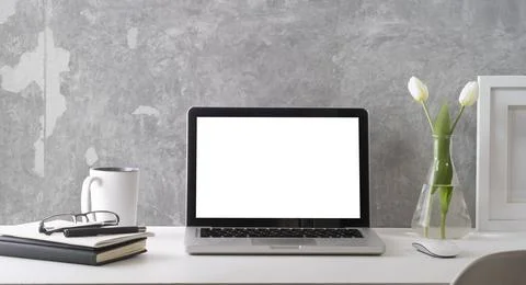 Front with laptop computer with white empty screen, picture frame, books and  Stock Photos