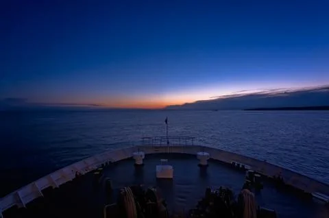 Front of a large passenger ferry sailing at dawn Stock Photos