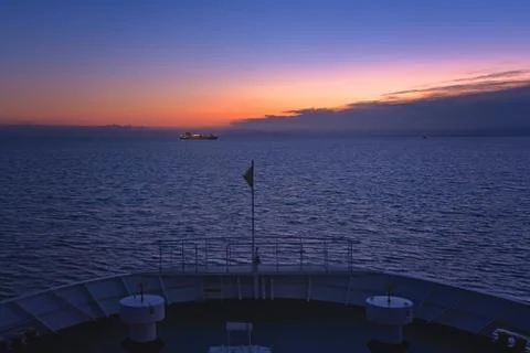 Front of a large passenger ferry sailing at dawn Stock Photos