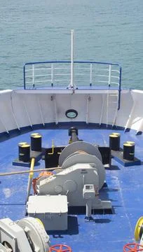 Front of a large ship sailing through blue waters Stock Photos