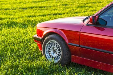 Front left side of an old German car that stands on green grass Stock Photos