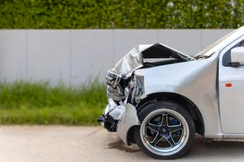 Front of light gray car big damaged and broken by accident on city street par Stock Photos