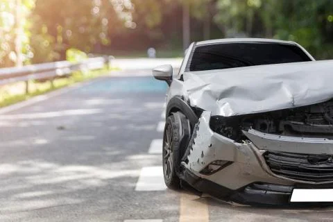 Front of light gray car big damaged and broken by accident on city street par Stock Photos