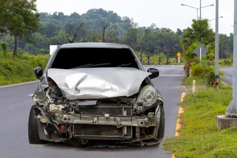 Front of light gray car big damaged and broken by accident on city street par Stock Photos